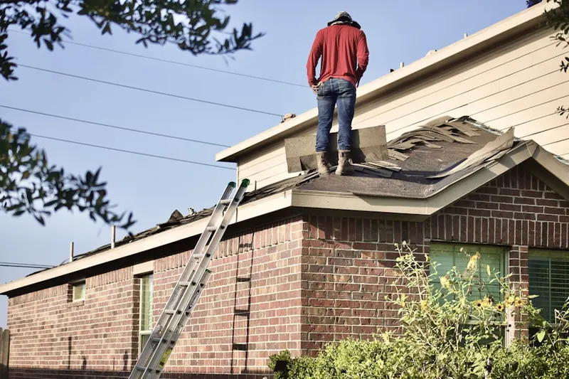 Professional roofer working on a residential roof in East Freeway Neighborhood
